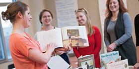 literacy student sharing a picture in a book