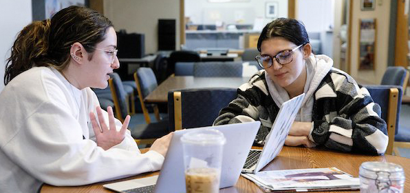 Career peer mentor reviewing a resume with a student