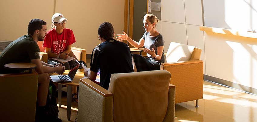 Professor Decker talking with a group of students