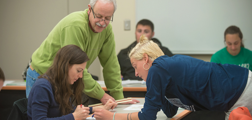 A graduate student works alongside an advisor