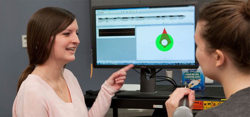 Student using computer equipment for the voice