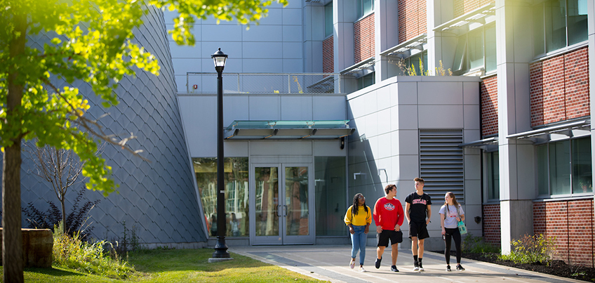 Students walking outside Bowers in the fall