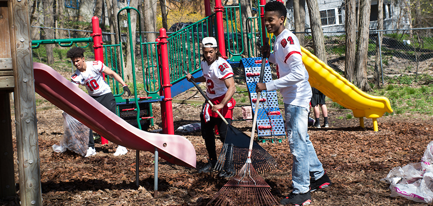 Football student-athletes participating in community service