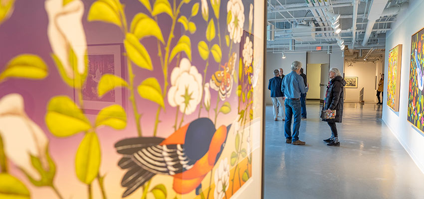 Community members visit an exhibit in the Dowd Gallery