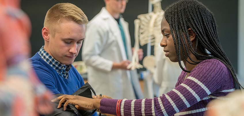 Pre-med Club members practice taking blood pressure