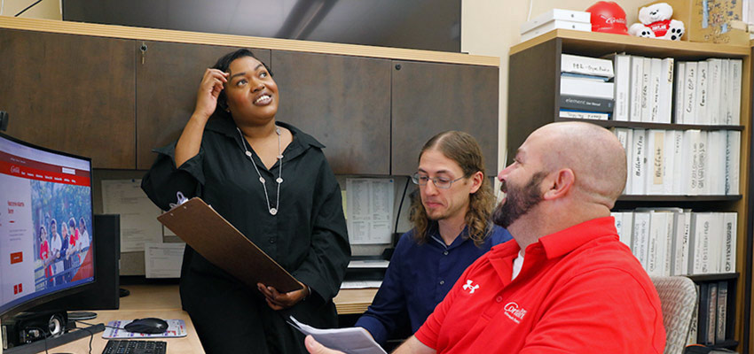 Camus Technology Services staff speaking in an office