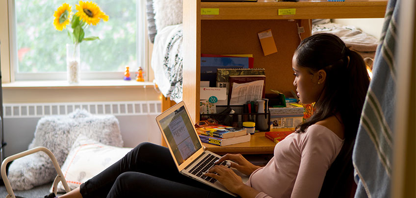 Student looking at their laptop