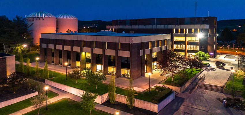 Aerial view of memorial library, lit by exterior lights at twilight