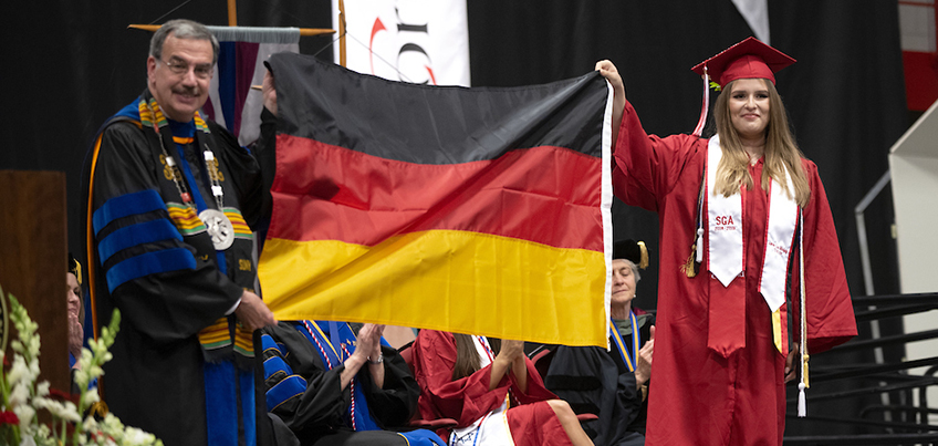 An international student is recognized at Commencement