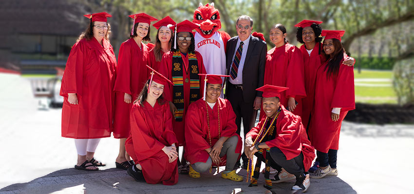 Happy graduates with Blaze and President Erik Bitterbaum