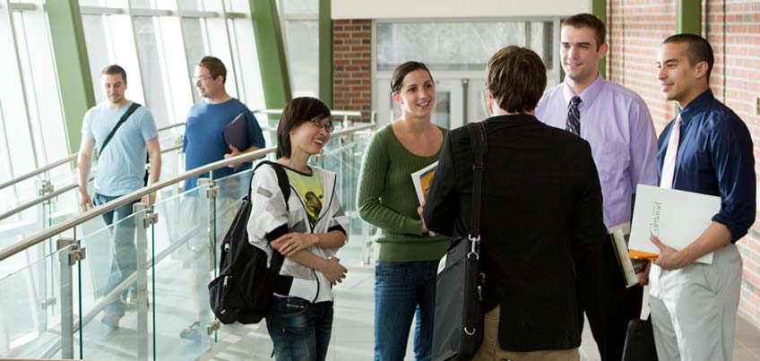 Graduate students chatting in Van Hoesen Hall