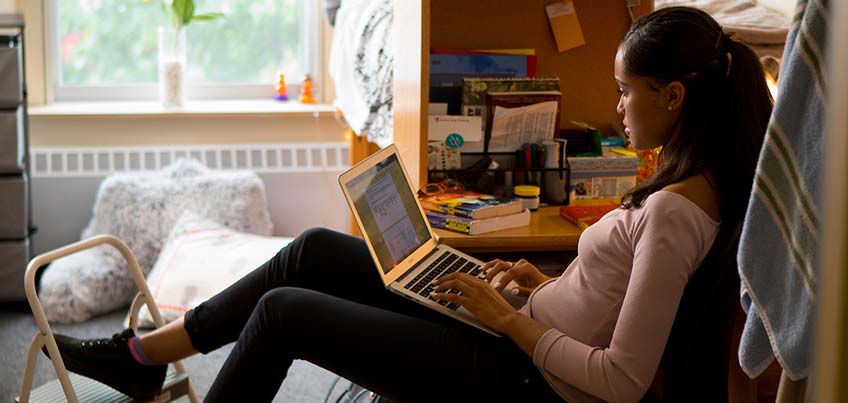 Student on laptop in her room