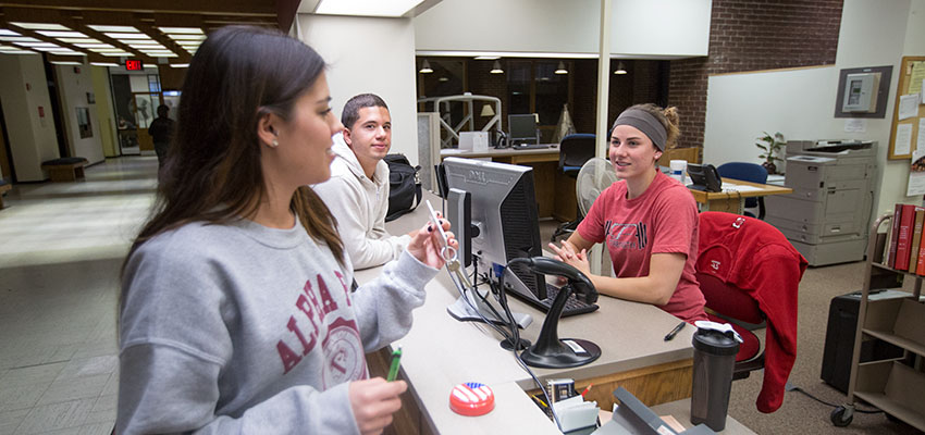 Student receives help from library staff working in The Help Center.