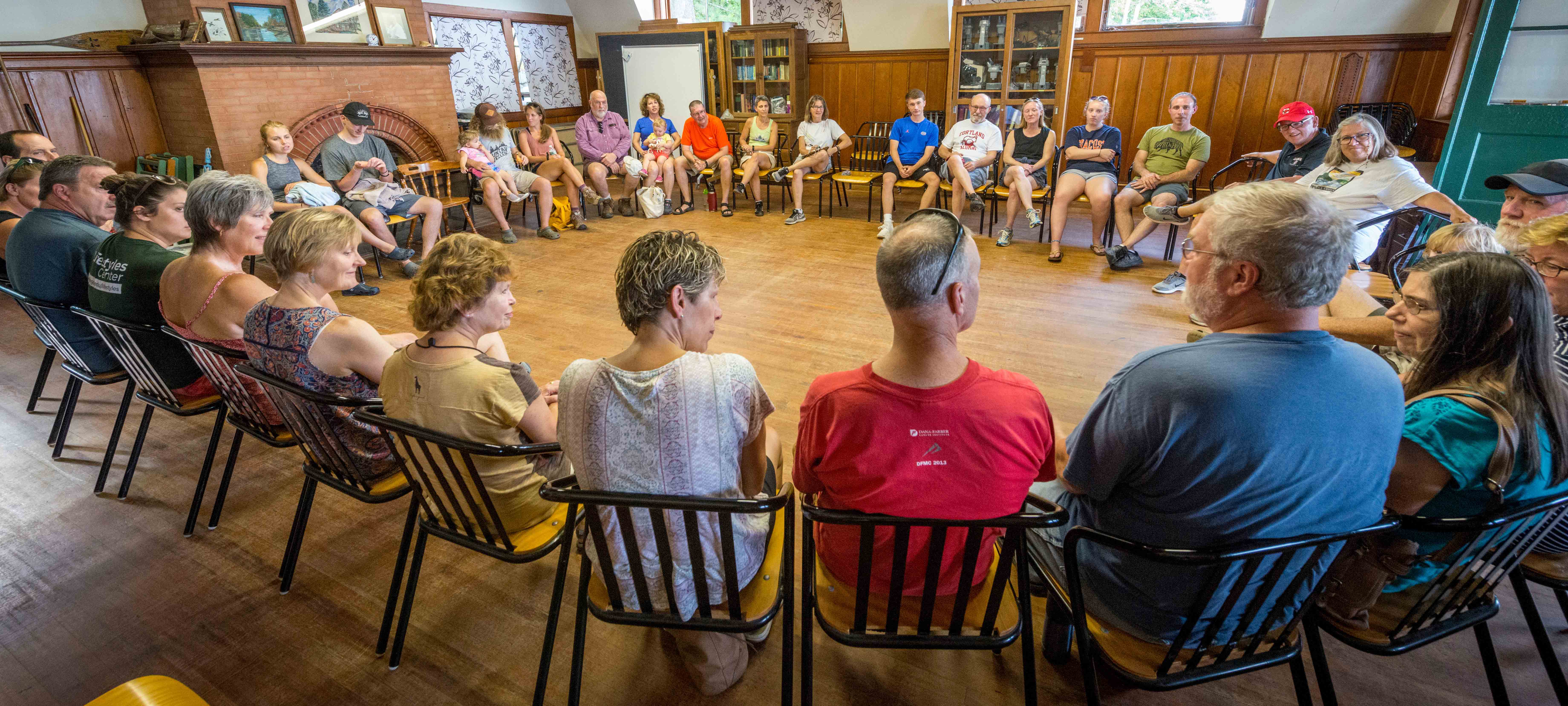 folks sitting in a circle of chairs