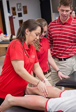 Student massaging calf muscle