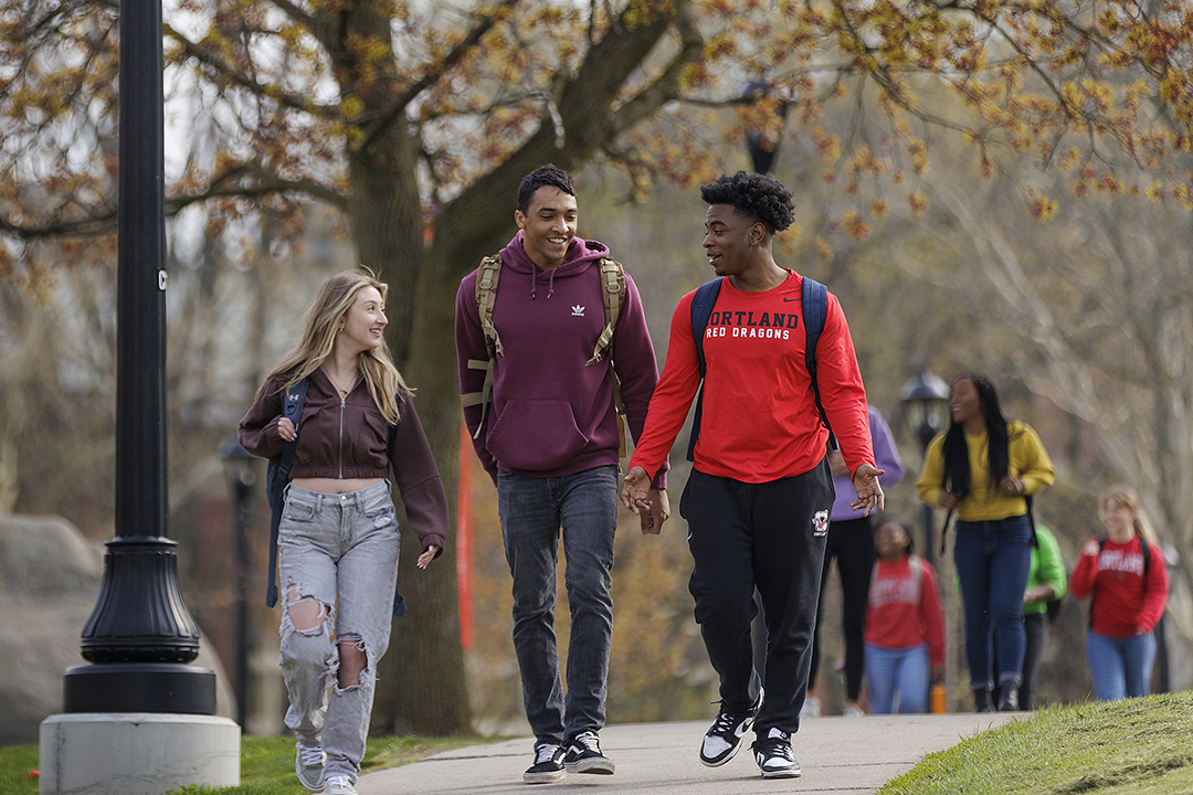 Three students walking on campus