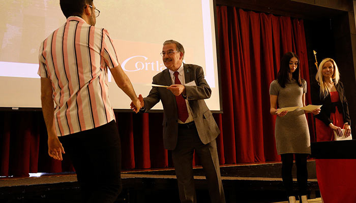 President Bitterbaum congratulating a student