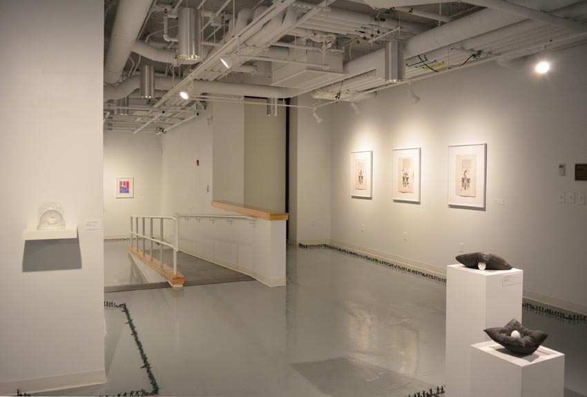 View into the central gallery at Dowd Gallery featuring sculptural objects produced by Jaroslava Prihodova, director of the Dowd Gallery, Jenn McNamara, professor of fiber arts, Szilvia Kadas, professor of graphic design, and installation by Bryan Valentine Thomas, instructor of design and drawing, at the Art and Art History Department.