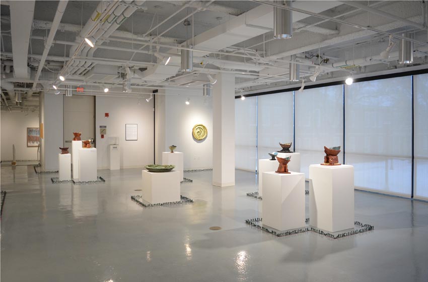 View into the central gallery at Dowd Gallery featuring sculptural objects produced by Jeremiah Donovan, professor of ceramics and floor installation by Bryan Valentine Thomas, instructor of design and drawing, at the Art and Art History Department.