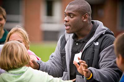 Recreation student explaining a game to local youth