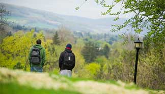 Two students taking in the beautiful view from SUNY Cortlands campus" 