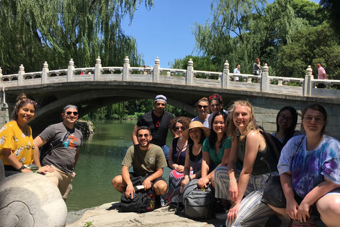 Students in front of a small bridge in China