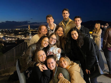 Students facing outward at night in Florence, Italy